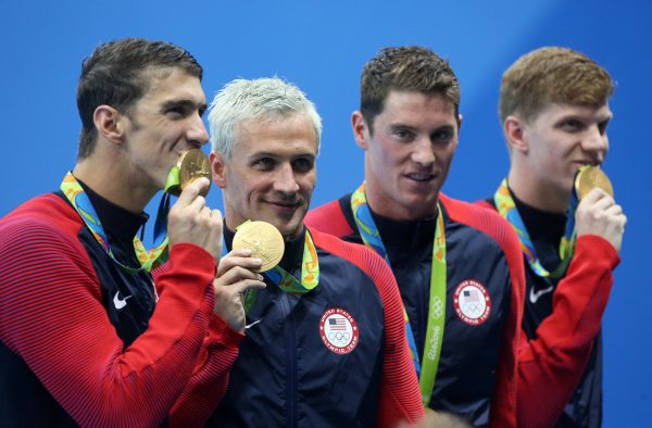 RIO DE JANEIRO, BRAZIL - AUGUST 9: Michael Phelps, Ryan Lochte, Conor Dwyer, Francis Haas of Team USA celebrate winning the gold medal during the medal ceremony of the men's 200m freestyle relay on day 4 of the Rio 2016 Olympic Games at Olympic Aquatics Stadium on August 9, 2016 in Rio de Janeiro, Brazil. (Photo by Jean Catuffe/Getty Images)