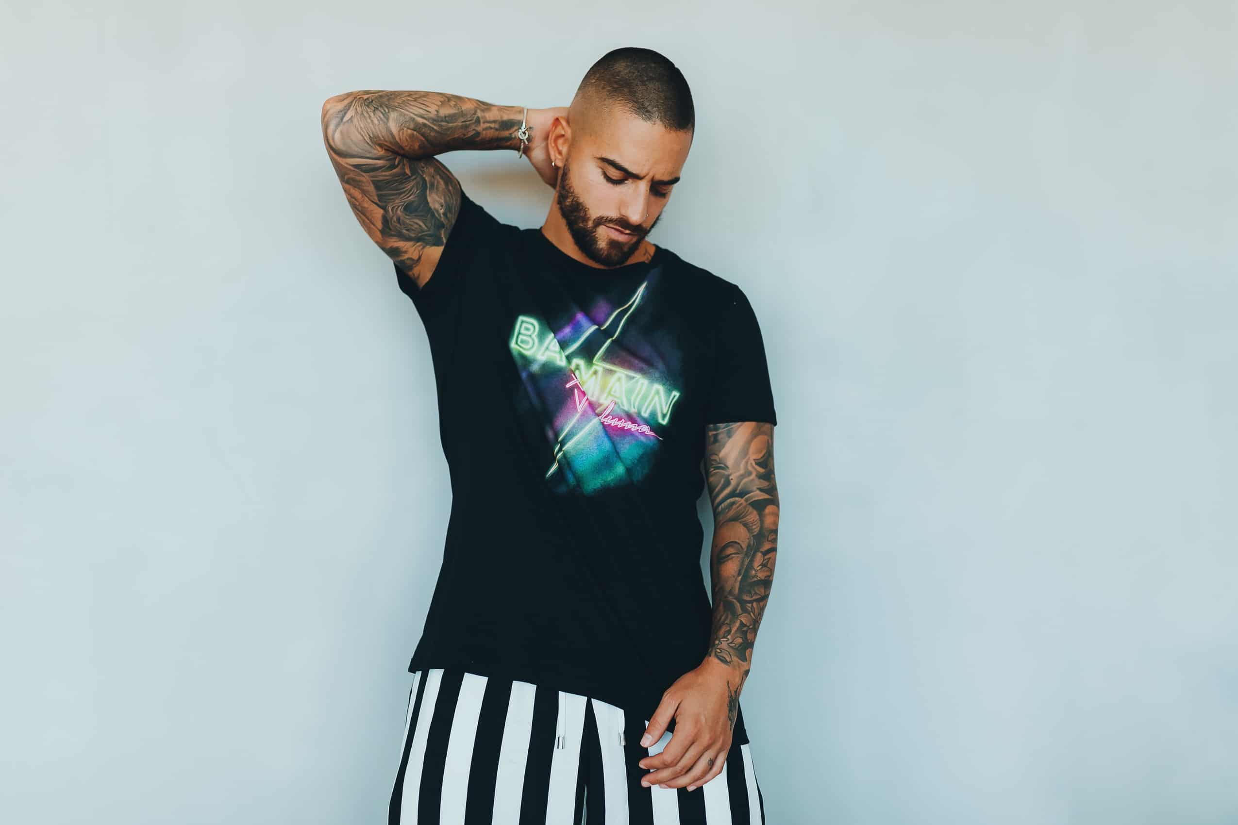 Maluma Bares Tattooed Biceps Arriving at Heron Preston Fashion